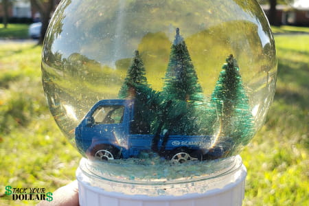 Snow globe with toy truck and pine trees